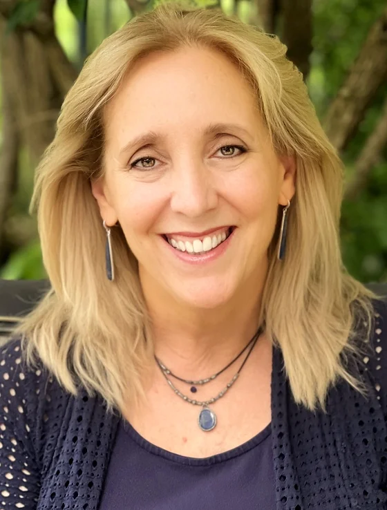 Maryanne Melloan Woods, blonde, hair, necklaces, earrings, smiling